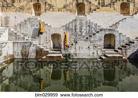 Stock Photo - Women in saris carrying water at step well, Jaipur, Rajasthan, India. Fotosearch