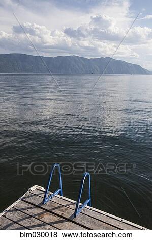 Stock Photo - Wooden deck in still lake. Fotosearch