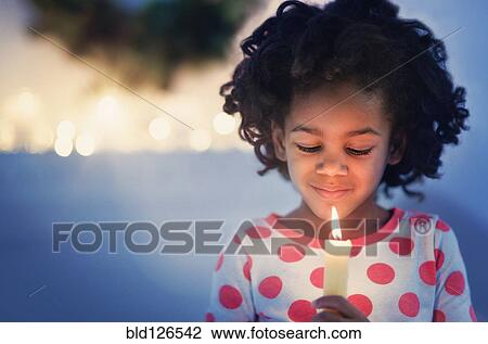 African American girl in pajamas holding lit candle View Large Photo Image Stock Image - African American girl in pajamas holding lit candle. Fotosearch