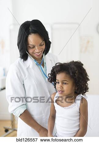 African American girl receiving checkup from doctor View Large Photo Image Stock Photo - African American girl receiving checkup from doctor. Fotosearch