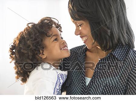 African American mother and daughter hugging and smiling View Large Photo Image Stock Image - African American mother and daughter hugging and smiling. Fotosearch