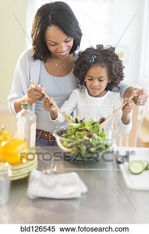 African American mother and daughter tossing salad View Large Photo Image Stock Photography - African American mother and daughter tossing salad. Fotosearch