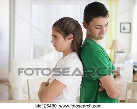 Angry Caucasian brother and sister standing back to back View Large Photo Image Stock Image - Angry Caucasian brother and sister standing back to back. Fotosearch