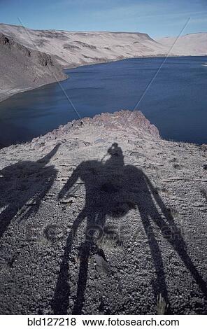 Stock Photo - Argentina Mendoza Province The Andes shadow of people on horseback. Fotosearch