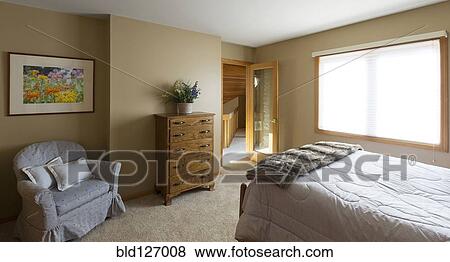 Stock Photo - Armchair and dresser in bedroom. Fotosearch