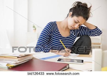 Asian student studying at table View Large Photo Image Stock Image - Asian student studying at table. Fotosearch