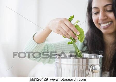 Stock Photo - Asian woman composting lettuce. Fotosearch