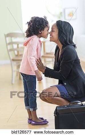 Stock Photo - Black mother and daughter rubbing noses. Fotosearch