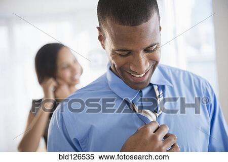 Stock Photography - Businessman getting dressed. Fotosearch