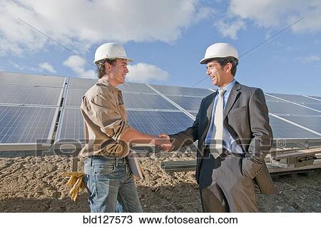 businessman shaking engineer's hand in solar plant View Large Photo Image Stock Image - businessman shaking engineer's hand in solar plant. Fotosearch