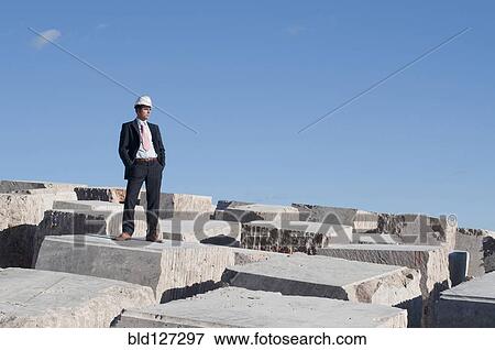 businessman standing on pile of marble blocks View Large Photo Image Stock Photo - businessman standing on pile of marble blocks. Fotosearch