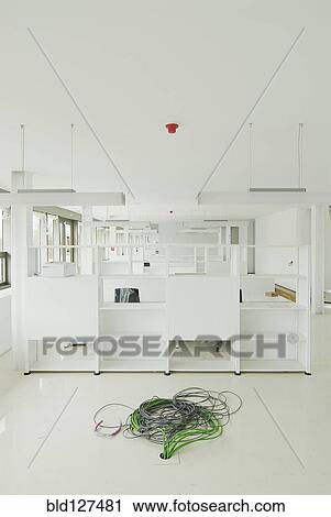 Stock Image - Cables in new empty office. Fotosearch