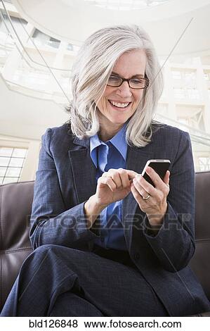 Caucasian businesswoman text messaging View Large Photo Image Stock Photo - Caucasian businesswoman text messaging. Fotosearch
