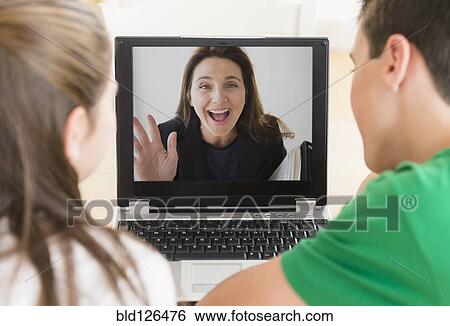 Caucasian children video conferencing with mother on laptop View Large Photo Image Stock Photograph - Caucasian children video conferencing with mother on laptop. Fotosearch