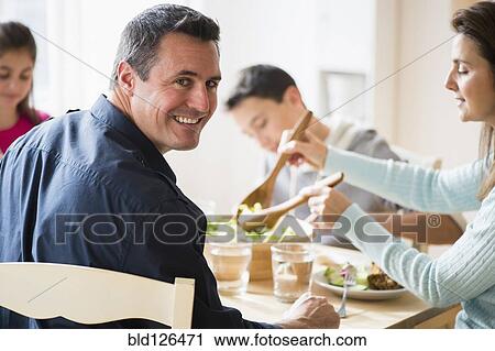 Caucasian family eating at table View Large Photo Image Stock Image - Caucasian family eating at table. Fotosearch