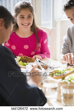Caucasian family eating at table View Large Photo Image Stock Image - Caucasian family eating at table. Fotosearch