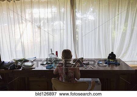 Caucasian girl coloring at desk View Large Photo Image Stock Photo - Caucasian girl coloring at desk. Fotosearch