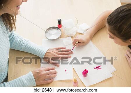 Caucasian girl giving mother a manicure View Large Photo Image Stock Image - Caucasian girl giving mother a manicure. Fotosearch