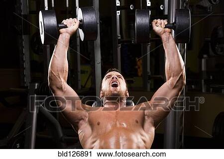 Caucasian man doing incline chest presses with dumbbells in gym View Large Photo Image Stock Image - Caucasian man doing incline chest presses with dumbbells in gym. Fotosearch