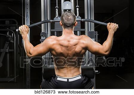 Caucasian man with bare chest lifting weights on machine View Large Photo Image Stock Image - Caucasian man with bare chest lifting weights on machine. Fotosearch