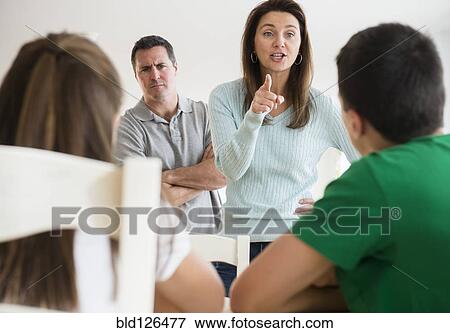 Stock Photo - Caucasian parents scolding children. Fotosearch
