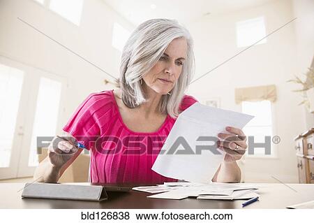 Stock Photo - Caucasian woman paying bills online. Fotosearch