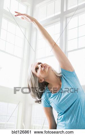 Caucasian woman practicing yoga View Large Photo Image Stock Image - Caucasian woman practicing yoga. Fotosearch