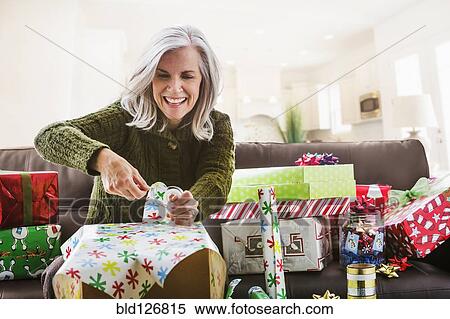 Caucasian woman wrapping Christmas gifts View Large Photo Image Stock Photography - Caucasian woman wrapping Christmas gifts. Fotosearch