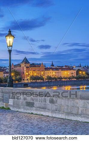 Stock Image - Charles Bridge and city illuminated at dawn, Prague, Czech Republic. Fotosearch