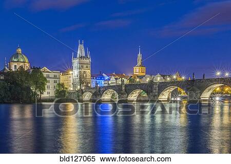 Stock Photography - Charles Bridge and city illuminated at night, Prague, Czech Republic. Fotosearch