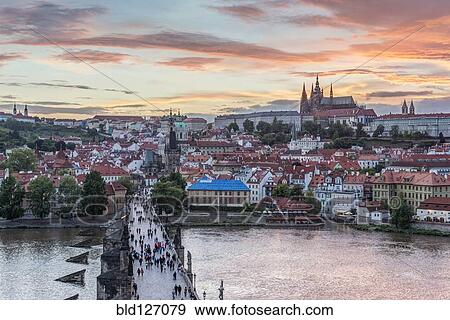 Stock Photo - Charles Bridge, Prague Castle and cityscape at sunset, Prague, Czech Republic. Fotosearch