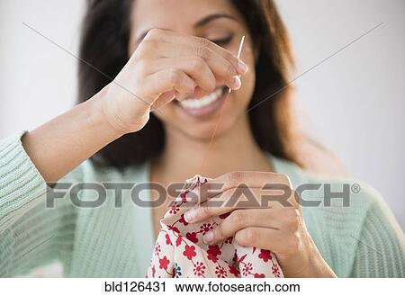 Close up of Asian woman sewing View Large Photo Image Stock Image - Close up of Asian woman sewing. Fotosearch
