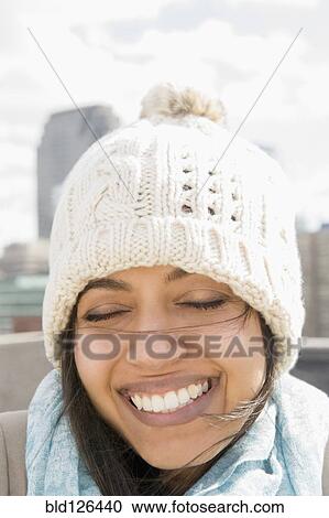 Close up of Asian woman smiling in knit hat with eyes closed View Large Photo Image Stock Image - Close up of Asian woman smiling in knit hat with eyes closed. Fotosearch