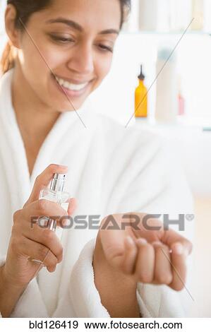 Close up of Asian woman spraying perfume on wrist View Large Photo Image Stock Photo - Close up of Asian woman spraying perfume on wrist. Fotosearch