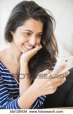 Close up of Asian woman text messaging with cell phone View Large Photo Image Picture - Close up of Asian woman text messaging with cell phone. Fotosearch