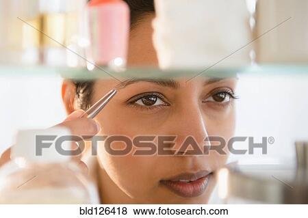 Close up of Asian woman tweezing eyebrows View Large Photo Image Stock Photo - Close up of Asian woman tweezing eyebrows. Fotosearch