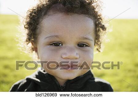 Close up of mixed race baby boy with curly hair View Large Photo Image Stock Photo - Close up of mixed race baby boy with curly hair. Fotosearch