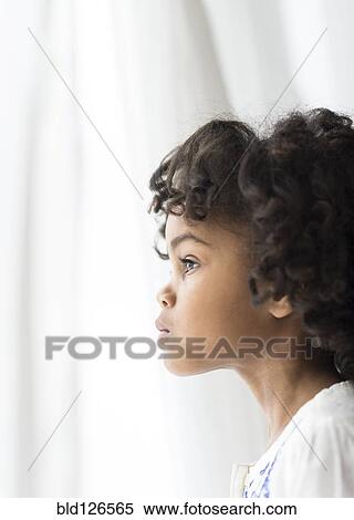 Close up of pensive African American girl looking out window View Large Photo Image Stock Photography - Close up of pensive African American girl looking out window. Fotosearch