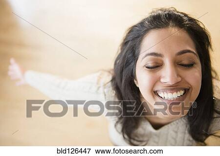 Stock Photo - Close up portrait of carefree Asian woman with eyes closed. Fotosearch