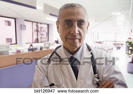 Close up portrait of confident Hispanic doctor in hospital View Large Photo Image Stock Photo - Close up portrait of confident Hispanic doctor in hospital. Fotosearch