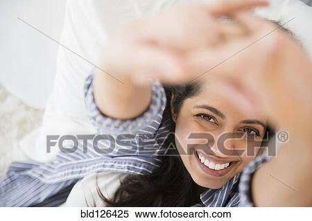 Close up portrait of smiling Asian woman laying in bed View Large Photo Image Stock Photography - Close up portrait of smiling Asian woman laying in bed. Fotosearch