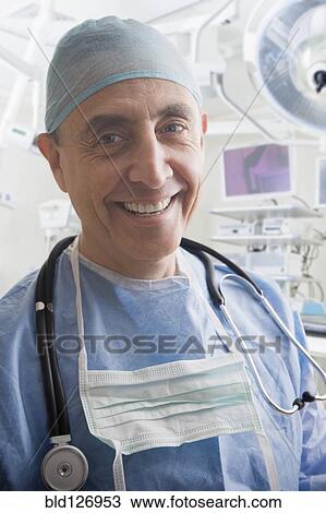 Stock Image - Close up portrait of smiling Hispanic surgeon. Fotosearch
