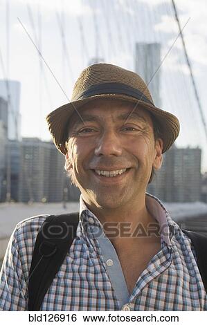 Stock Photograph - Close up portrait of smiling Hispanic man. Fotosearch
