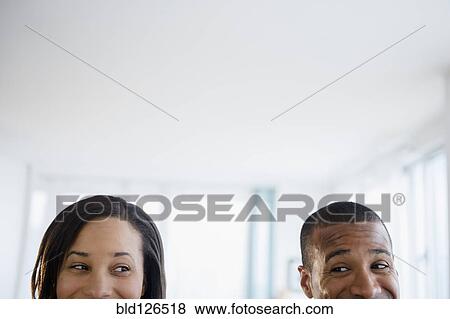 Couple engaged in sideways glance View Large Photo Image Stock Photo - Couple engaged in sideways glance. Fotosearch