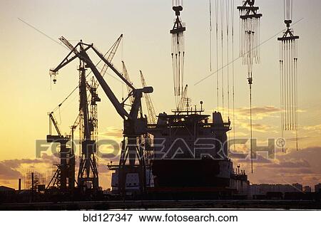 Cranes and a Tanker Moored at a Harbour at Sunset View Large Photo Image Stock Photo - Cranes and a Tanker Moored at a Harbour at Sunset. Fotosearch