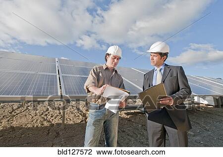 Stock Image - engineer and businessman in solar plant. Fotosearch