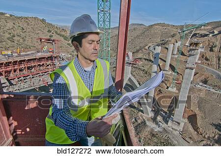 engineer with plans at bridge construction site View Large Photo Image Stock Image - engineer with plans at bridge construction site. Fotosearch