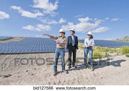 Stock Photograph - engineers and businessman in solar plant. Fotosearch