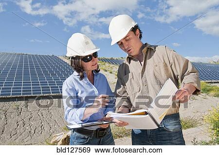 engineers looking at plans in solar plant View Large Photo Image Stock Photo - engineers looking at plans in solar plant. Fotosearch