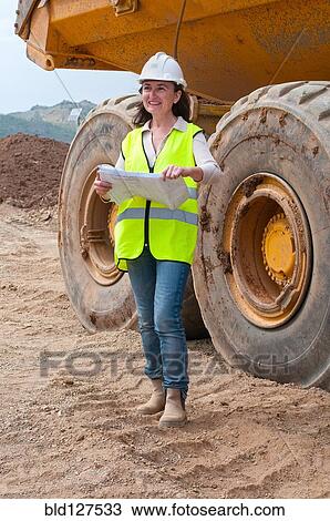female engineer with plan next to dump truck View Large Photo Image Stock Image - female engineer with plan next to dump truck. Fotosearch
